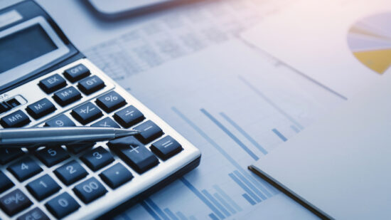 finance accounting concept. pen and calculator on table